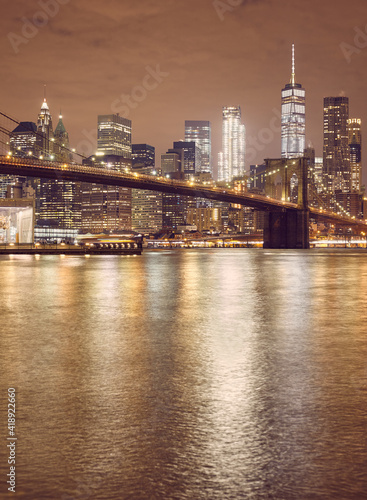 Brooklyn Bridge and New York City skyline at night  color toning applied  USA.