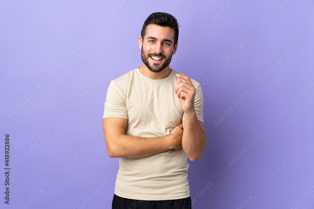 Young handsome man with beard over isolated background laughing Young handsome man with beard over isolated background laughing