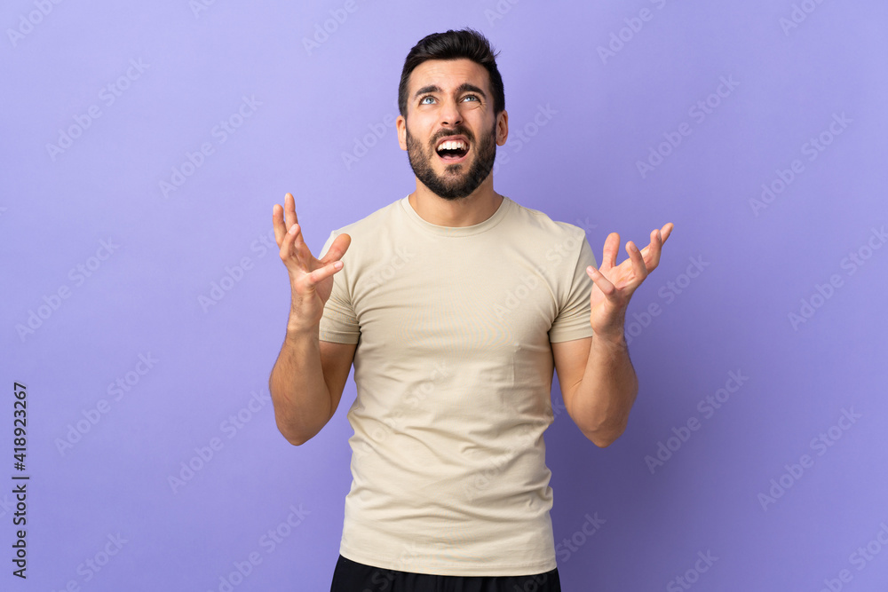 Young handsome man with beard over isolated background stressed overwhelmed Young handsome man with beard over isolated background stressed overwhelmed
