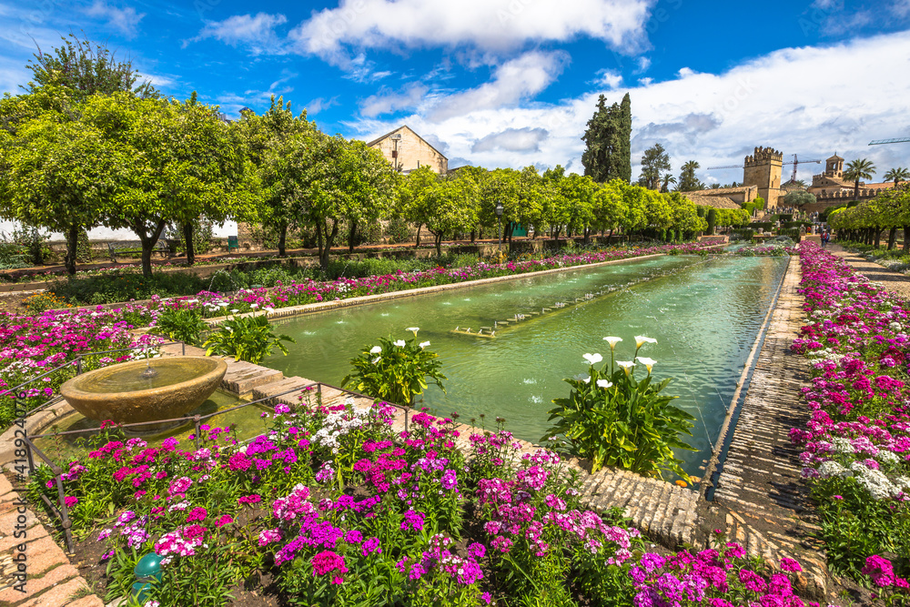 Fototapeta premium Cordoba, Andalusia, Spain - April 20, 2016: The colorful and blooming gardens in the spring of Alcazar de los Reyes Cristianos in Cordoba, Andalusia, Spain.