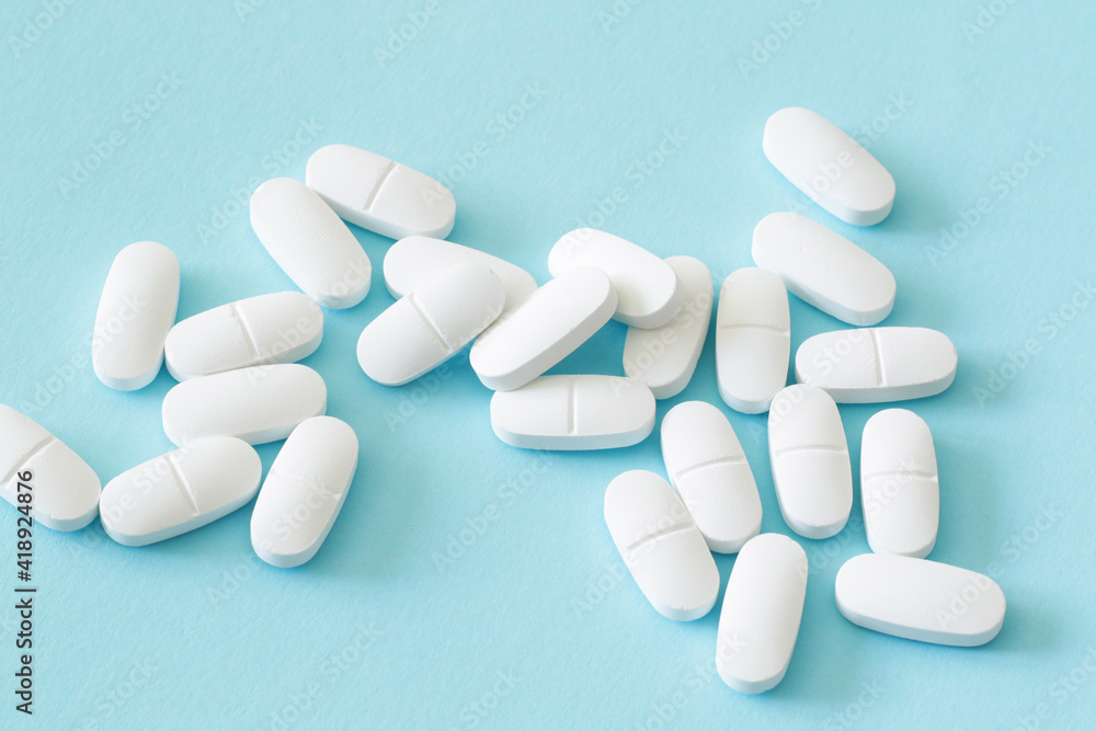 lot of medicine pills on blue background lot of medicine pills on blue background