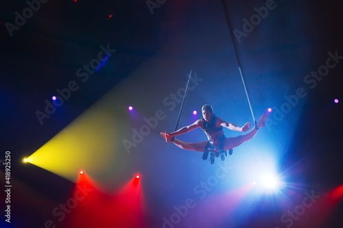 Circus actress acrobat performance. The acrobat perform acrobatic elements in the air