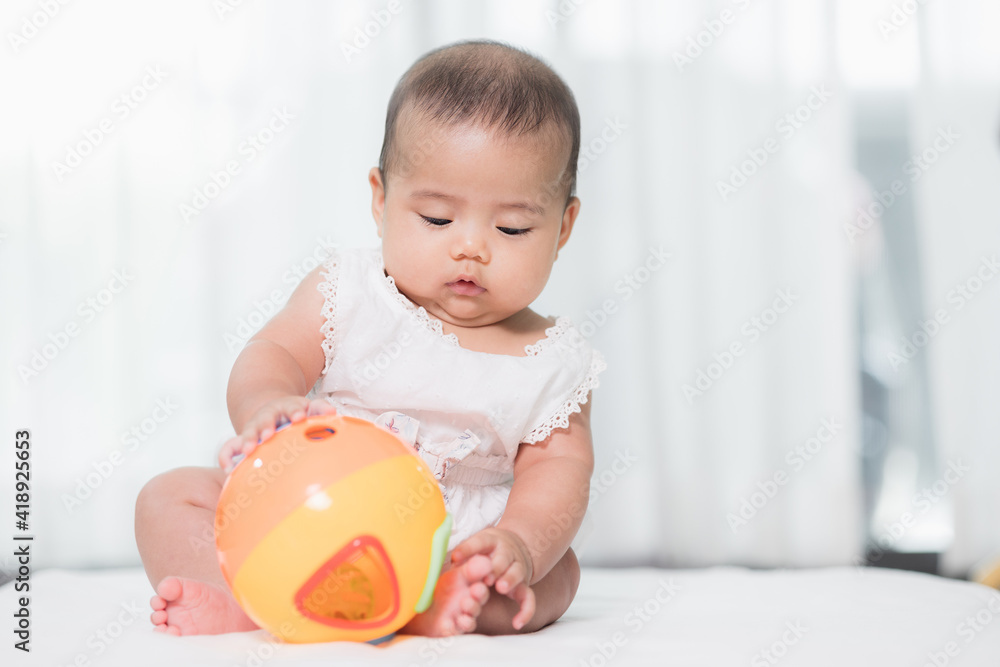 Asian baby cute in the living room at home playing ball toy with family. Asian baby cute in the living room at home playing ball toy with family.