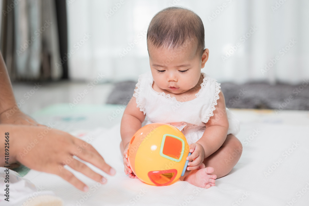 Asian baby cute in the living room at home playing ball toy with family. Asian baby cute in the living room at home playing ball toy with family.