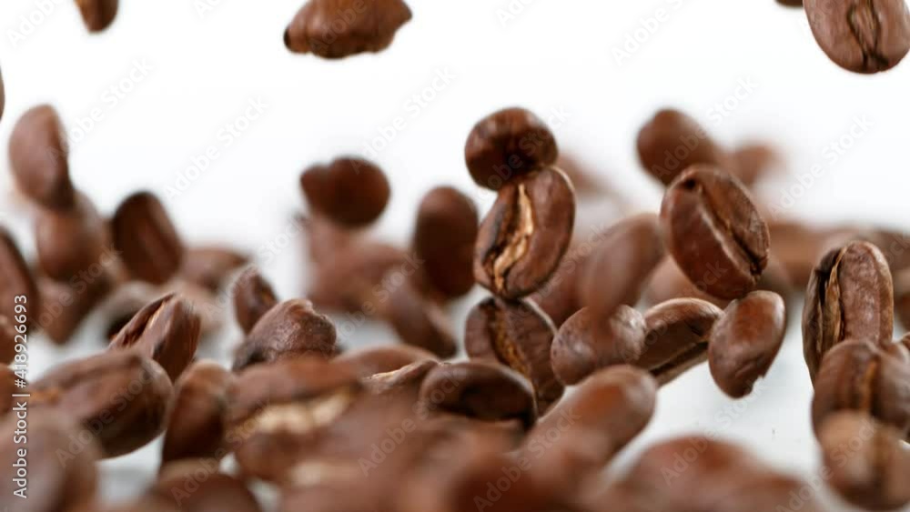 Super Slow Motion Shot of Falling Roasted Coffee Beans on White Background at 1000fps Super Slow Motion Shot of Falling Roasted Coffee Beans on White Background at 1000fps