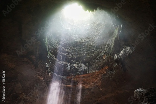 Fototapeta Naklejka Na Ścianę i Meble -  Beautiful ray of light inside Jomblang Cave, Yogyakarta, Indonesia