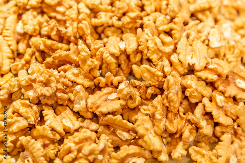 Textured surface of dry walnut of the Juglandaceae family. Healthy food ingredient Textured surface of dry walnut of the Juglandaceae family. Healthy food ingredient