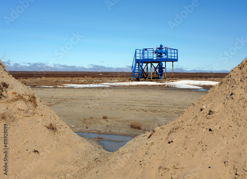 Oil and gas industry. A single gas well in the tundra beyond the Arctic Circle in early spring.