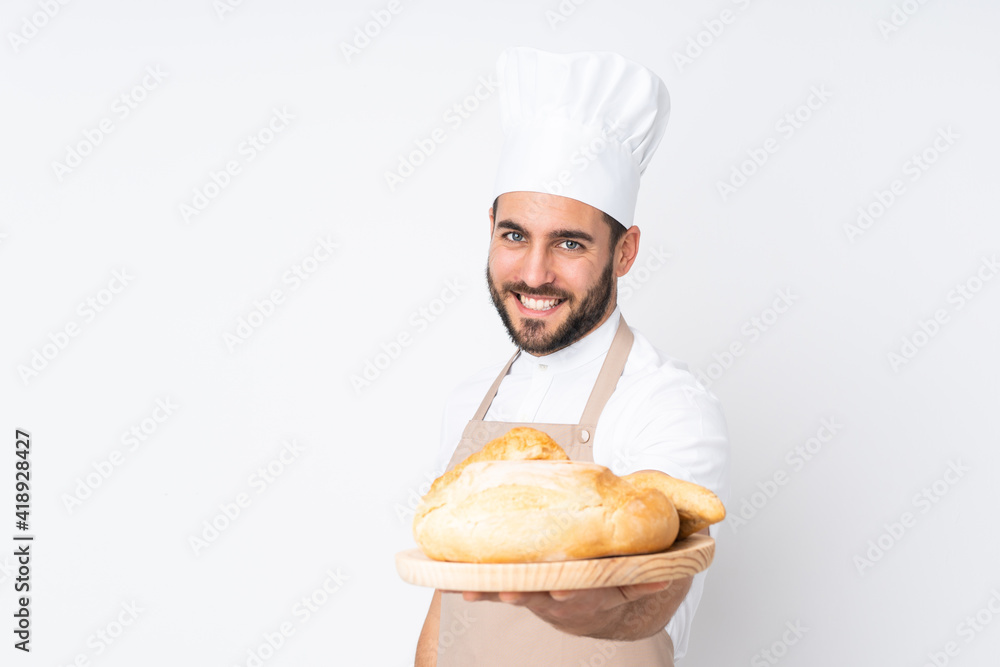 Male baker holding a table with several breads isolated on white background Male baker holding a table with several breads isolated on white background