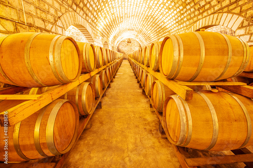  Wine Cellar with Wooden Barrels  Wine barrels stacked in the cellar of the winery