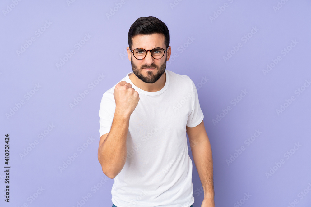 Caucasian handsome man over isolated background with unhappy expression Caucasian handsome man over isolated background with unhappy expression