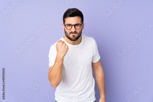 Caucasian handsome man over isolated background with unhappy expression