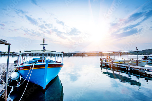 Obraz na płótnie Breathtaking upbeat inspirational landscape with a boat on a lake near pier at dawn near Vlacherna Monastery on the Kanoni peninsula in Kerkyra, Corfu, Greece. amazing places. w salonie