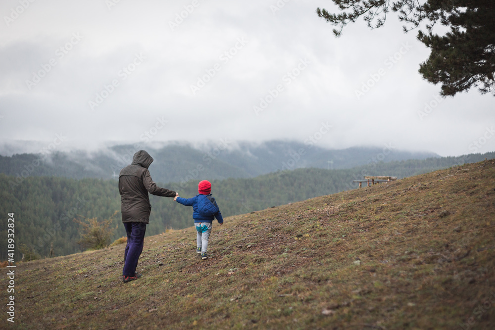 Mother and child walking in the mountains