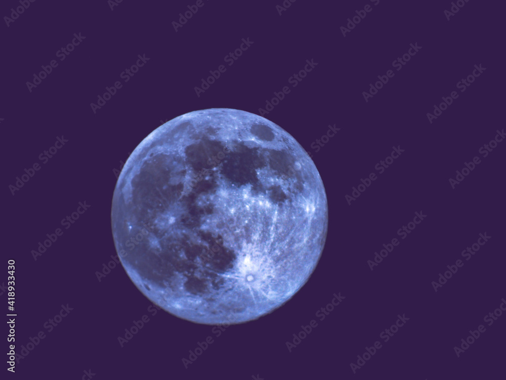 Obraz premium Earth's Moon Glowing with different colours in the Background. Blue and red moon watched by telescope.