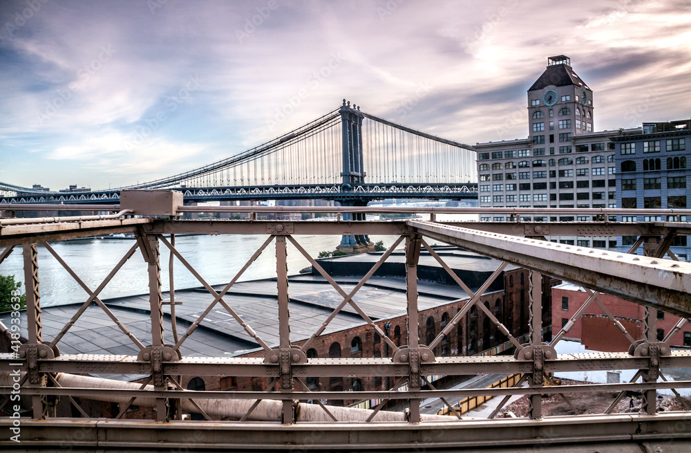 The Brooklyn bridge in New York with the Manhattan skyline on the background. The Brooklyn bridge in New York with the Manhattan skyline on the background.