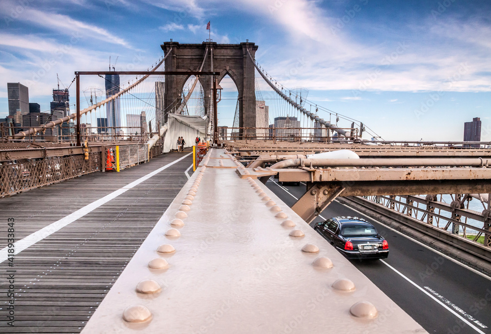 Fototapeta premium The Brooklyn bridge in New York with the Manhattan skyline on the background.