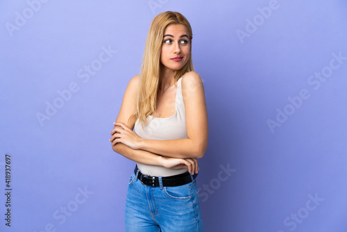 Young Uruguayan blonde woman over isolated background making doubts gesture while lifting the shoulders © luismolinero
