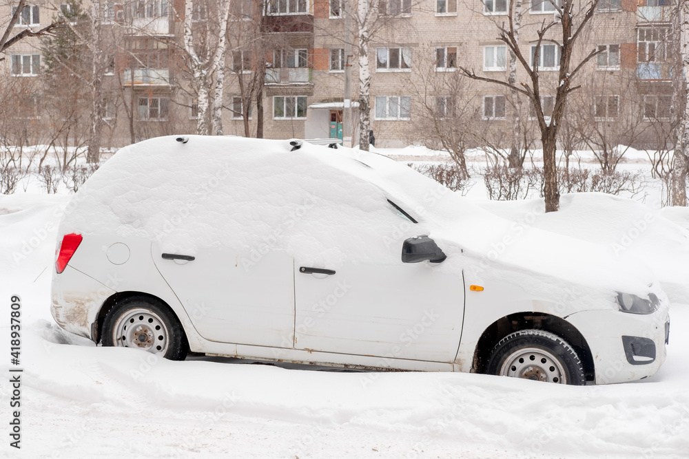 Kazan/Russia-03.05.2021 white car under the snow. heavy snowfall. effects of snowfall. abnormal winter.  