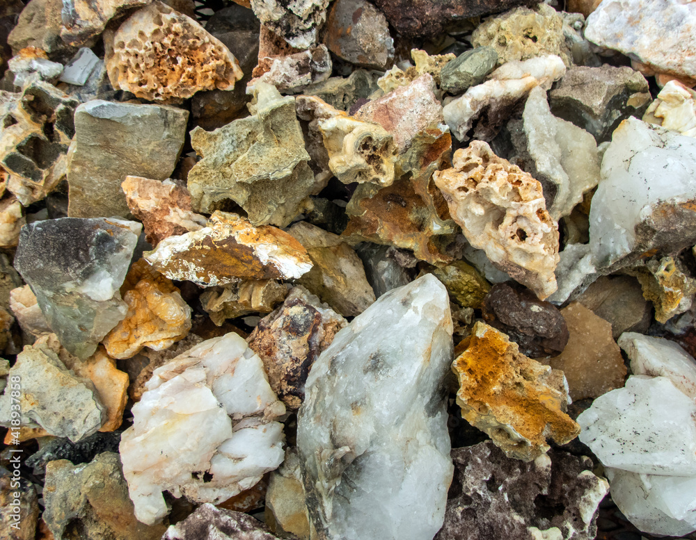 A mcaro photograph of a heap of various rocks and minerals full of interesting shapes, sizes and textures with a slight defocused effect. A delight for the rock collector