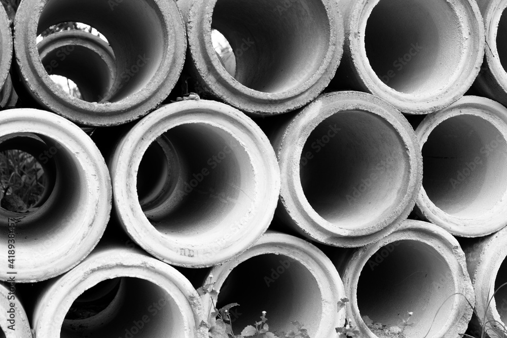 Pile of concrete sewer pipes on concrete plant grounds Pile of concrete sewer pipes on concrete plant grounds