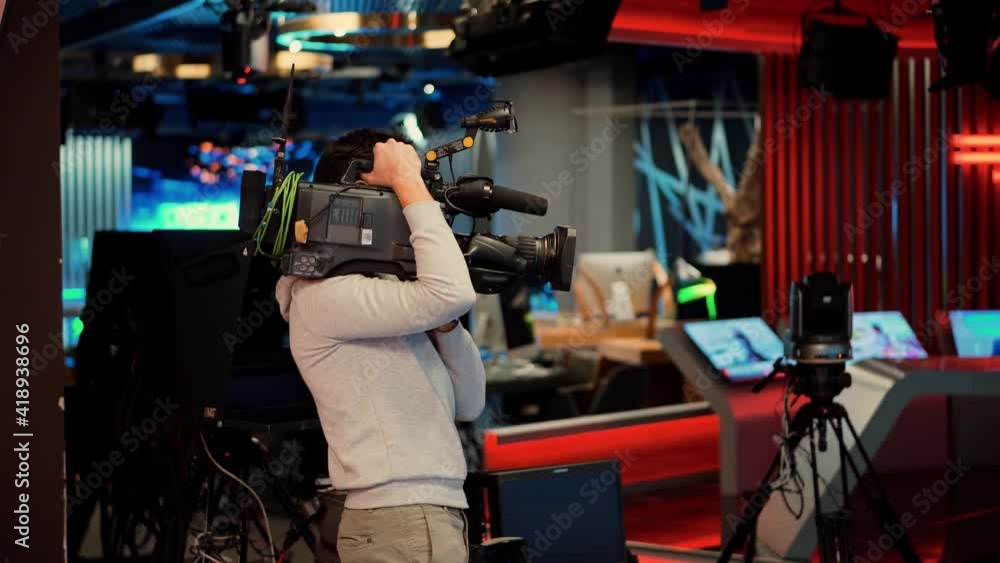 Television Operator On TV Broadcasting Production Channel. Camera Operator On News Room Shoot Media Movie.Camerawoman Working In TV Studio Video Production Filming Interview.Making TV Show Or Film. Television Operator On TV Broadcasting Production Channel. Camera Operator On News Room Shoot Media Movie.Camerawoman Working In TV Studio Video Production Filming Interview.Making TV Show Or Film.