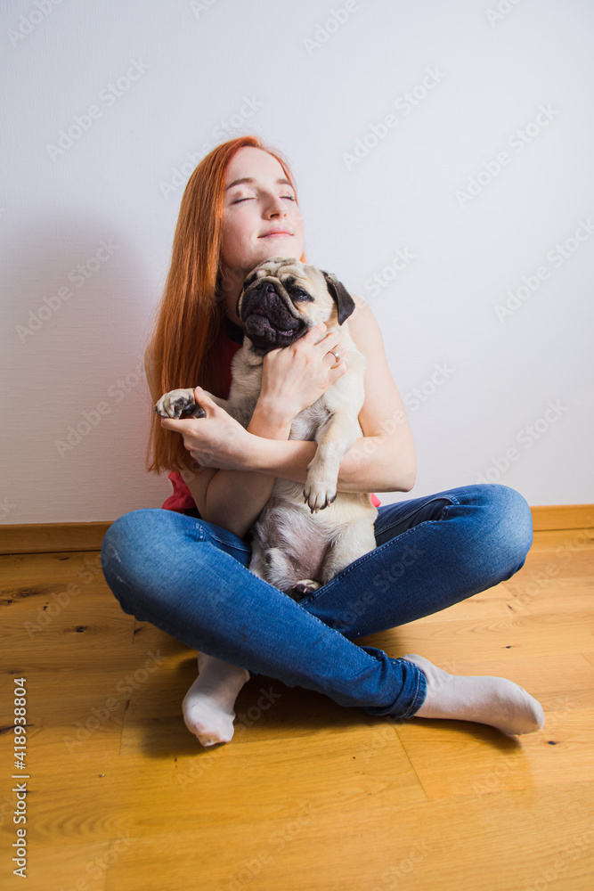 The young woman has a great time with her favorite pug The young woman has a great time with her favorite pug