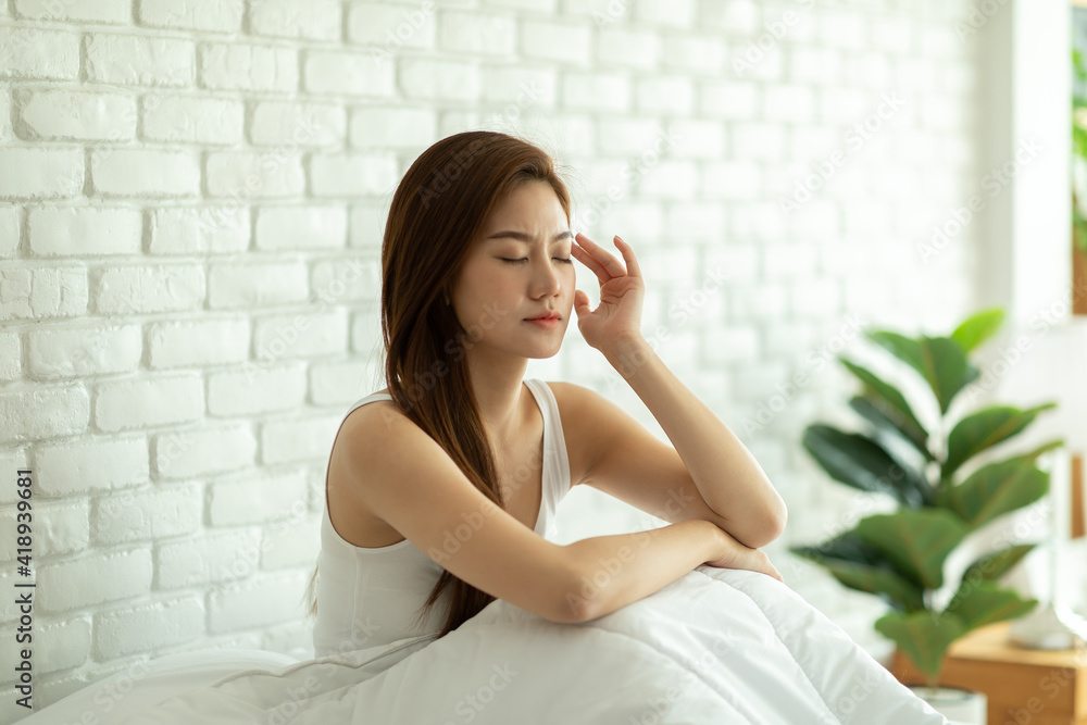 Asian young Woman has a Migraine and headache after wake up in the morning,Healthcare Concept Asian young Woman has a Migraine and headache after wake up in the morning,Healthcare Concept