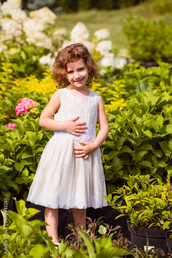 Little girls dancing among wonderful blooming flowers Little girls dancing among wonderful blooming flowers