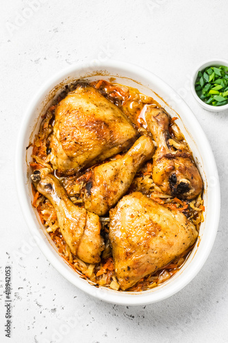 Roasted garlic chicken and vegetables in baking dish. Space for text, top view.