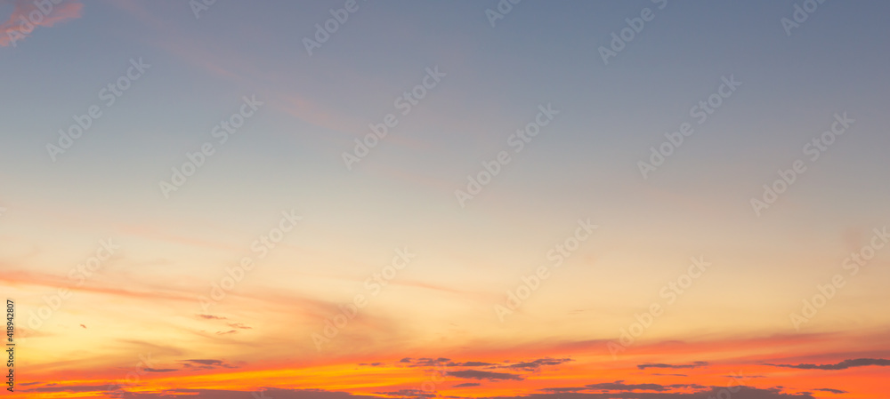 Fototapeta premium Beautiful Vivid sky painted by the sun leaving bright golden shades.Dense clouds in twilight sky in winter evening.Image of cloud sky on evening time.Evening Vivid sky with clouds.