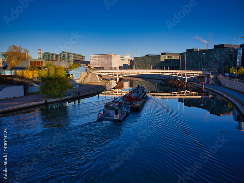 Photography Looking at a boat on the Spree River with Berlin's main train station in the background