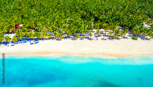 Paradise tropical island nature background. Top aerial drone view of beautiful beach with turquoise sea water and palm trees. Saona island, Dominican republic.