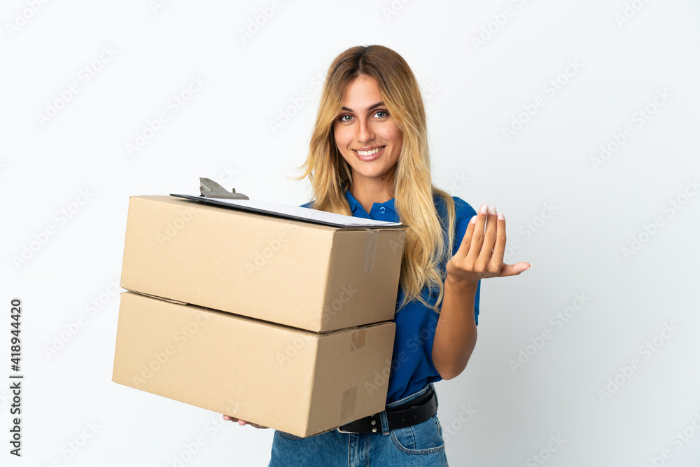 Young blonde Uruguayan delivery woman isolated on white background inviting to come with hand. Happy that you came Young blonde Uruguayan delivery woman isolated on white background inviting to come with hand. Happy that you came
