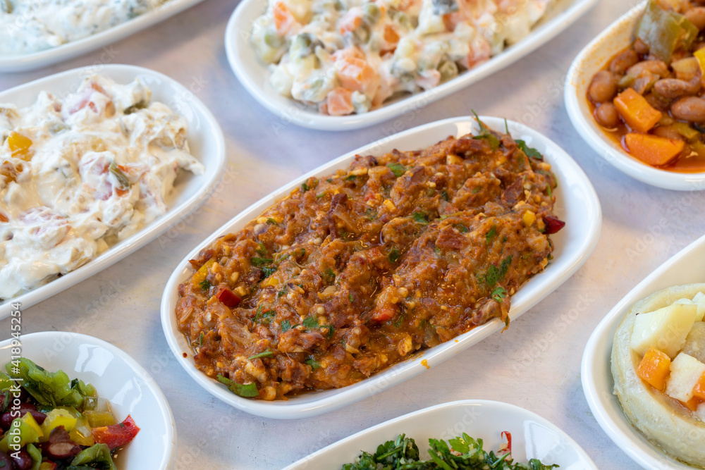 Spicy appetizer. Traditional Turkish and Arabic cuisine meze. Snack meal served alongside the main course. Natural vegetarian food. Local name yandım hacer. Bulk appetizer plates