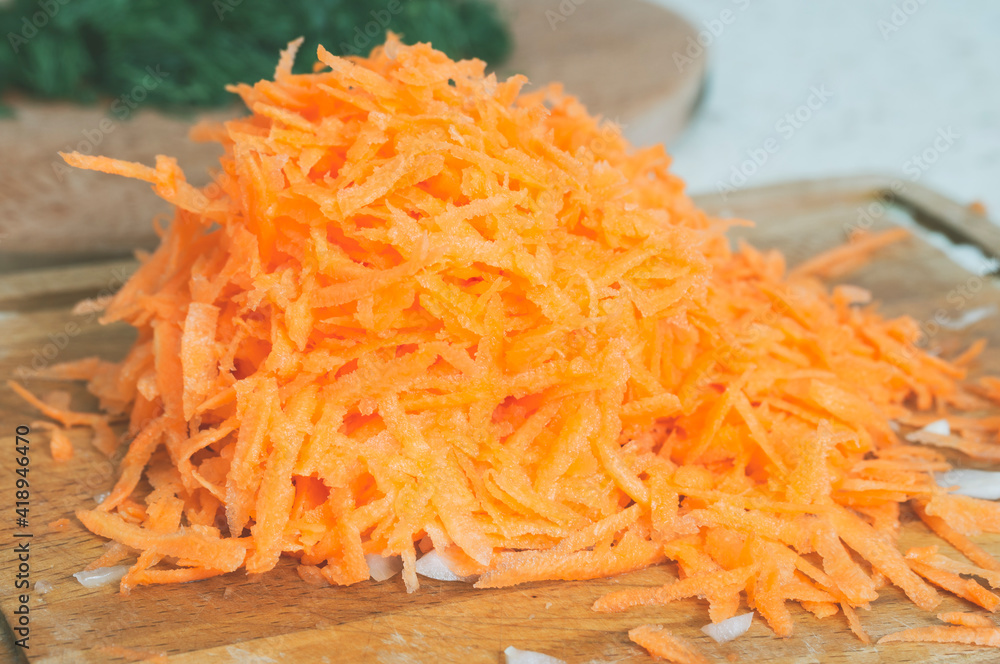 grated carrots on a cutting Board close up grated carrots on a cutting Board close up