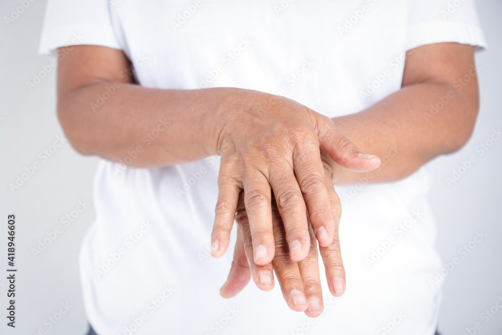 Elderly woman in white clothes wash their hands with alcohol gel. Prevent infection from the coronavirus. Concept of protection against COVID-19 virus Elderly woman in white clothes wash their hands with alcohol gel. Prevent infection from the coronavirus. Concept of protection against COVID-19 virus