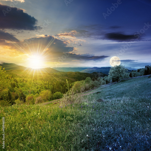 day and night equinox time change concept above mountainous countryside scenery in spring. trees and grass on hills rolling through green valley in to the distant ridge with sun and moon on the sky