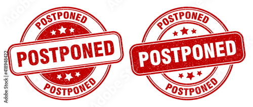 postponed stamp. postponed label. round grunge sign photo