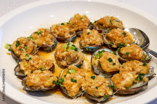 A delicious Chinese Cantonese dish, steamed fresh abalone with garlic © Steve