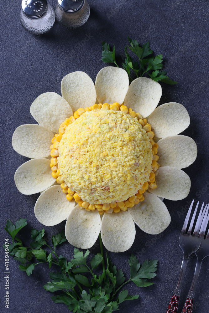 Fototapeta premium Festive salad Chamomile with eggs, corn and chips on dark background. View from above