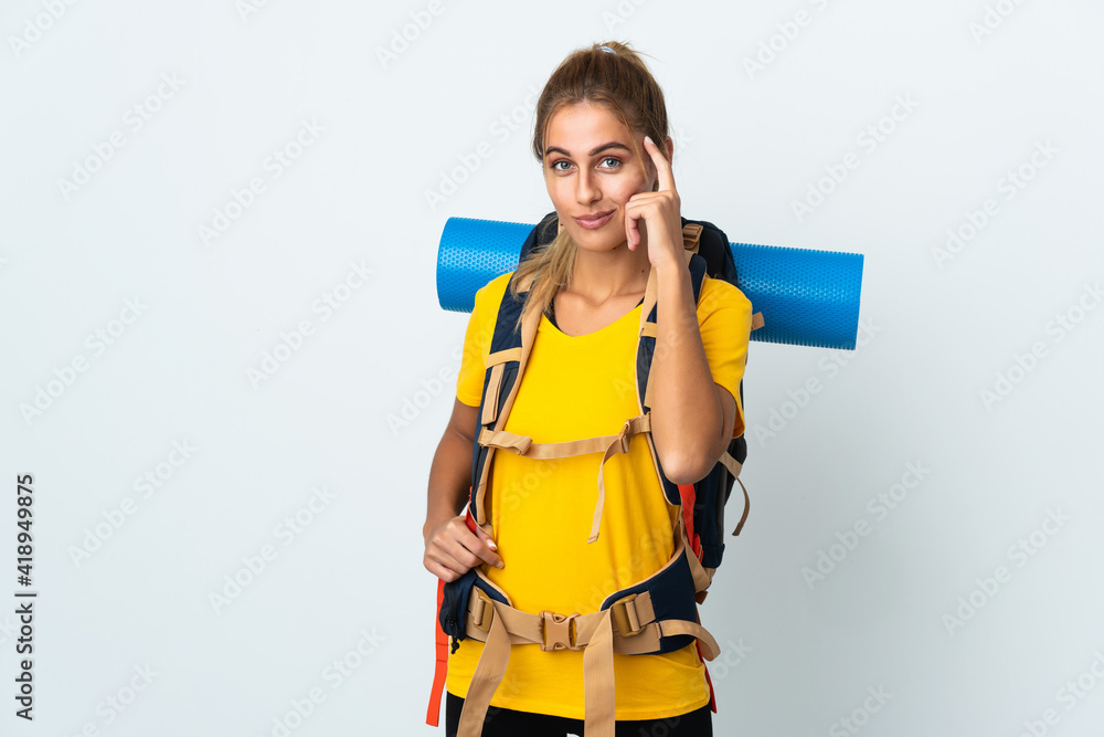 Young mountaineer woman with a big backpack isolated on white background thinking an idea Young mountaineer woman with a big backpack isolated on white background thinking an idea