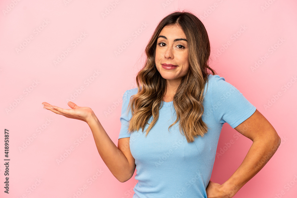 Young caucasian woman isolated doubting and shrugging shoulders in questioning gesture. Young caucasian woman isolated doubting and shrugging shoulders in questioning gesture.