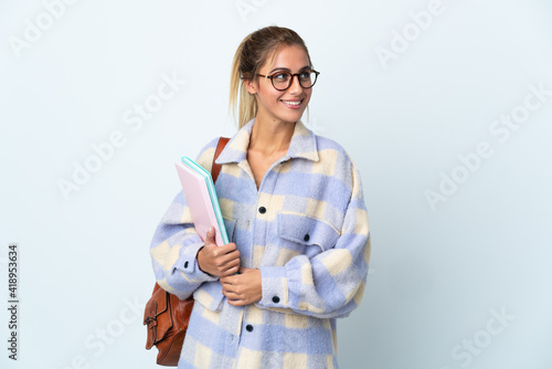 Young student woman isolated on white background looking side