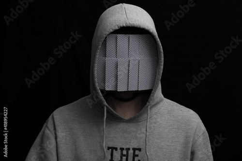 Man in hoodie with mask of playing cards hiding face