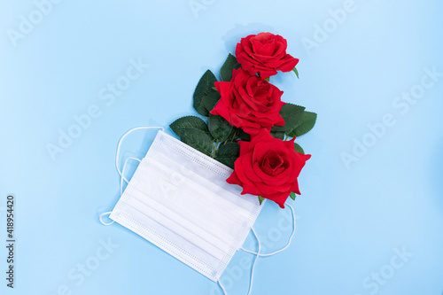 beautiful roses protected by a mask, background for messages, creative concept for Valentine's Day or Mother's Day