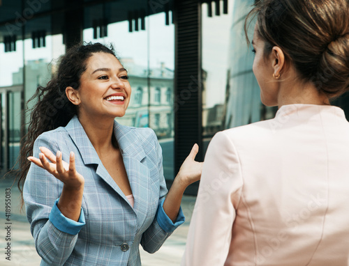 Two business women having a casual meeting or discussion in the city.