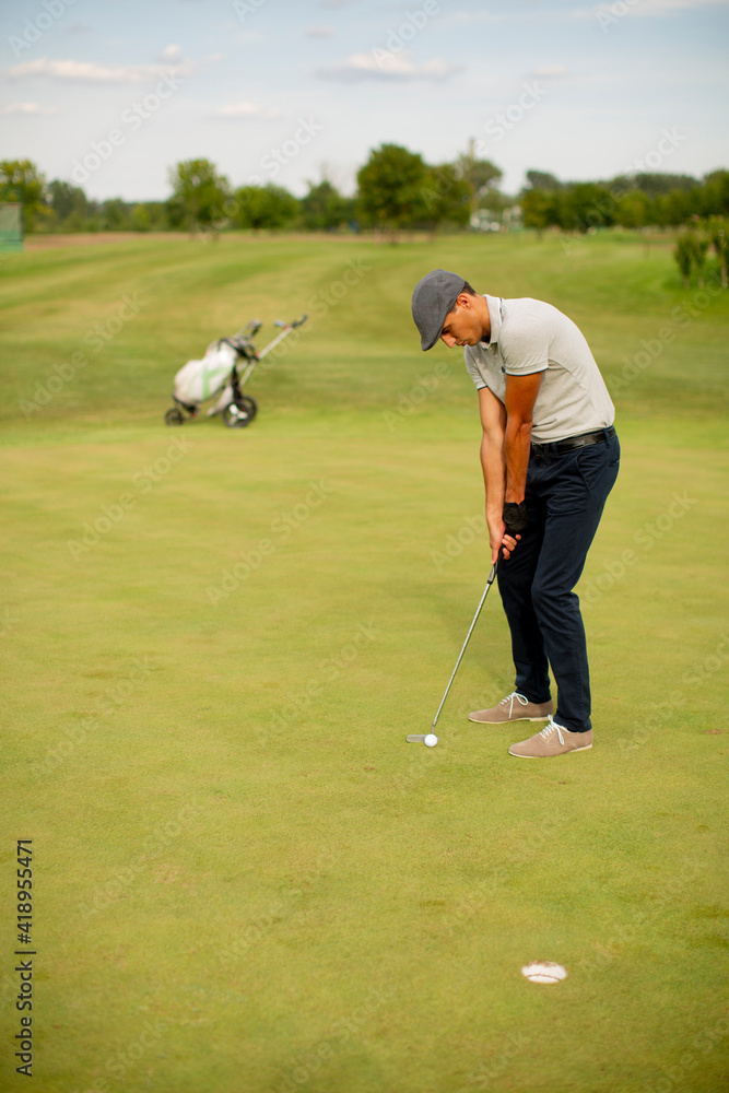 Fototapeta premium Young man playing golf