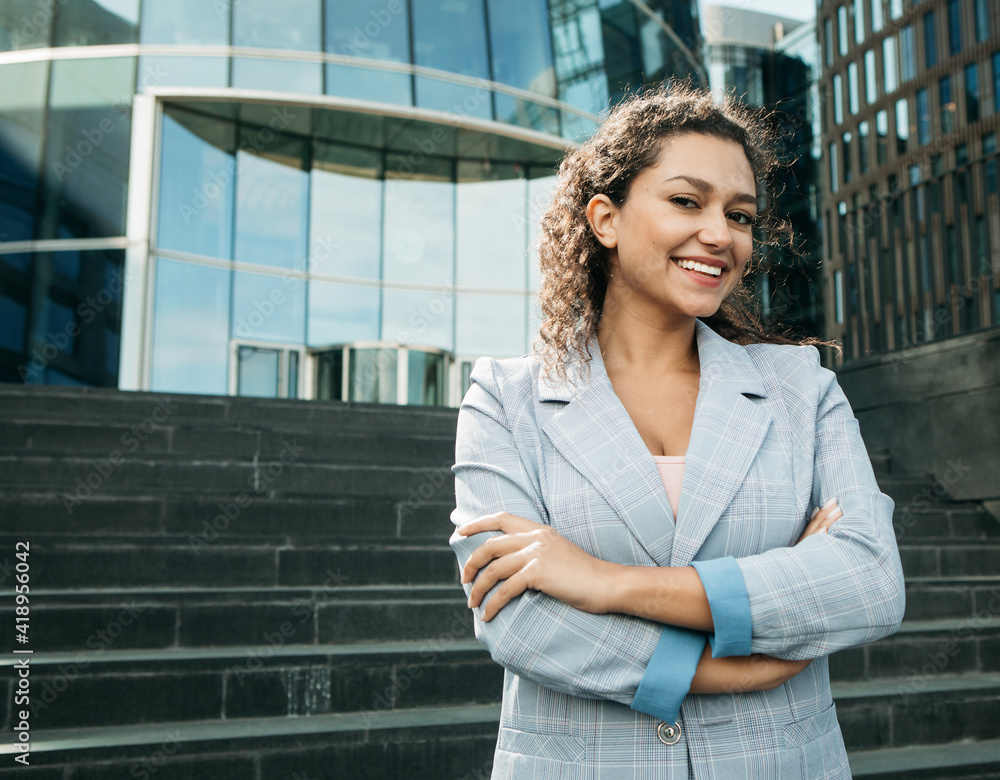 Young african american woman near modern business center, summer day, business concept Young african american woman near modern business center, summer day, business concept