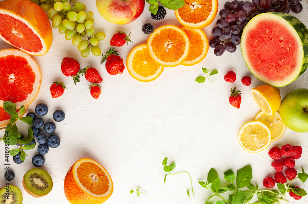 Assorted fresh fruits and berries on white background. Clean eating, healthy life. Top view. Assorted fresh fruits and berries on white background. Clean eating, healthy life. Top view.